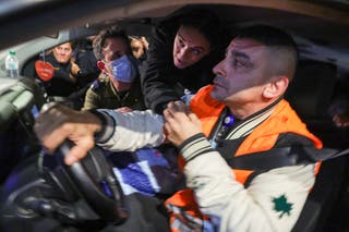 Emily Damari (centre) reaches to shake hands with her friends while being transported with two other hostages upon arriving at Sheba Tel HaShomer Medical Centre in Ramat Gan on Sunday
